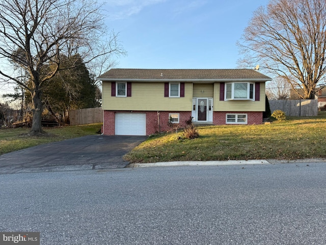 bi-level home featuring a front yard and a garage