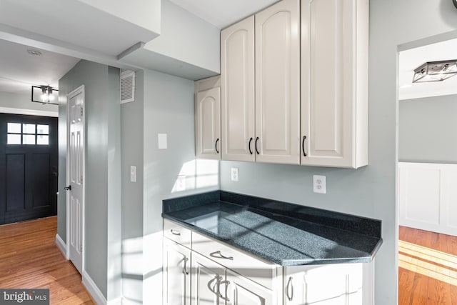 kitchen with white cabinets and light hardwood / wood-style flooring