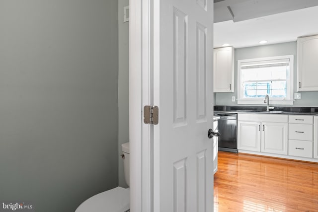 bathroom featuring toilet, vanity, and hardwood / wood-style flooring