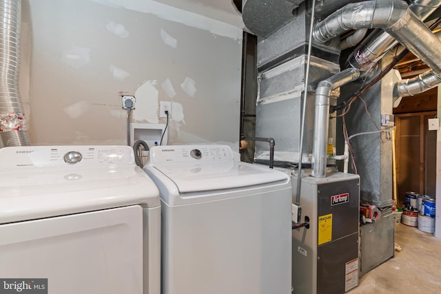 clothes washing area featuring washer and clothes dryer