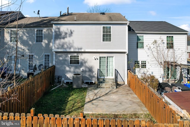 back of property with central air condition unit and a patio