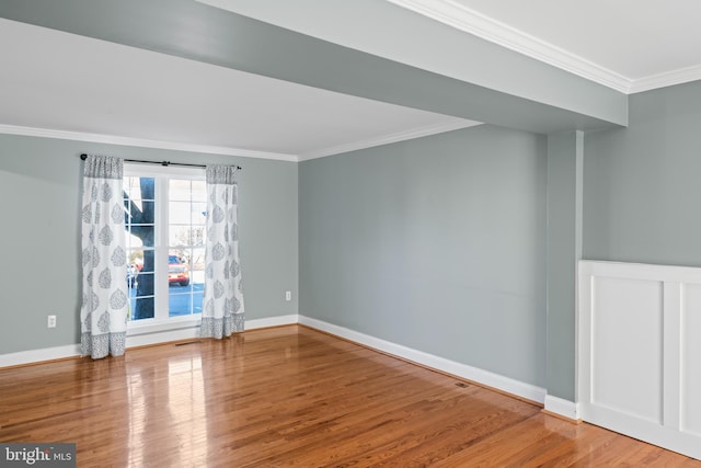 empty room featuring crown molding and hardwood / wood-style floors