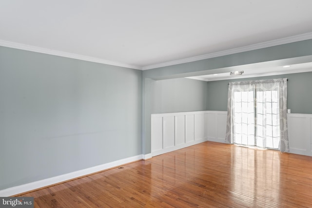 unfurnished room featuring crown molding and light hardwood / wood-style floors