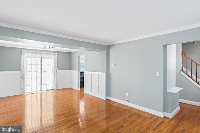 unfurnished room with light hardwood / wood-style flooring and ornamental molding