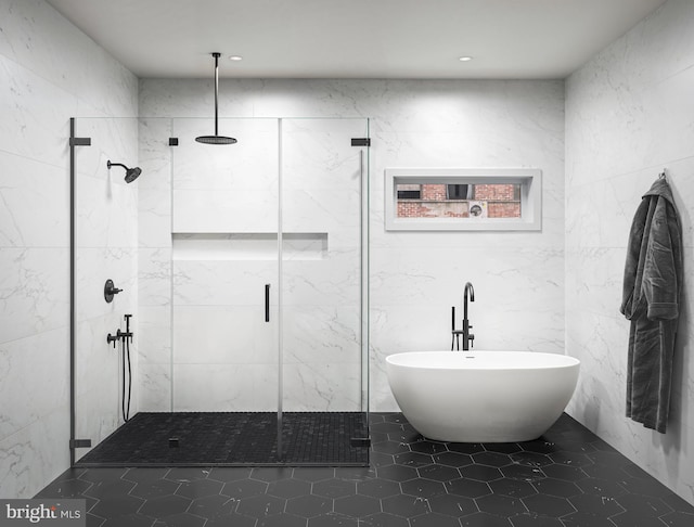 bathroom with tile patterned floors, tile walls, and independent shower and bath