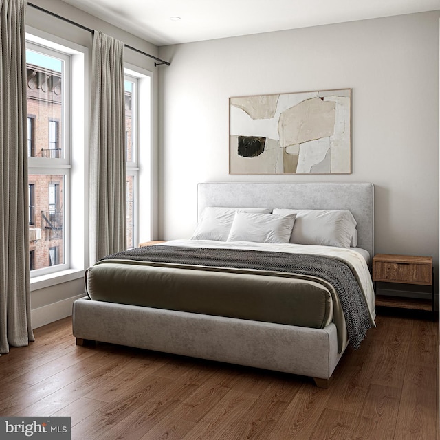 bedroom featuring dark hardwood / wood-style floors and multiple windows