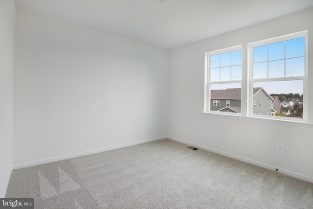 unfurnished room featuring carpet