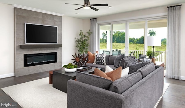 living room featuring a fireplace, ceiling fan, and dark wood-type flooring