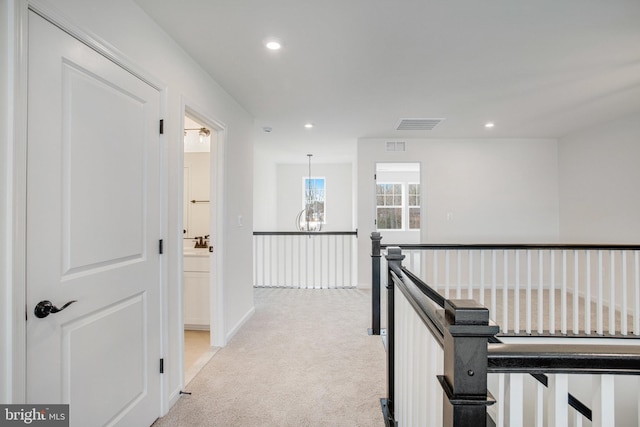 hallway featuring light carpet