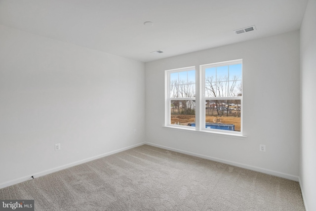 unfurnished room featuring carpet