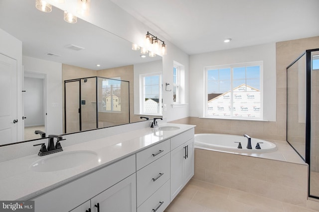 bathroom with tile patterned flooring, vanity, separate shower and tub, and a wealth of natural light