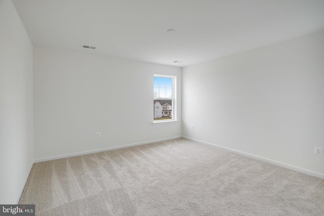 spare room with light colored carpet