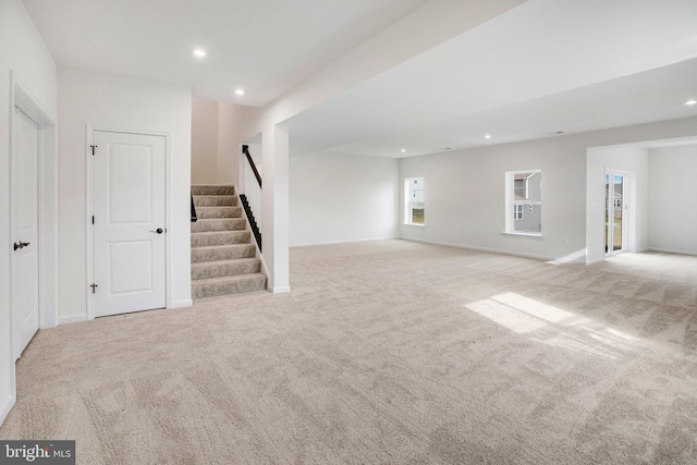 unfurnished living room with light colored carpet