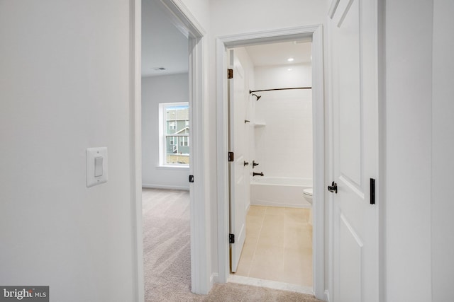 hallway with light tile patterned floors