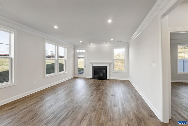 unfurnished living room featuring crown molding and dark wood-type flooring