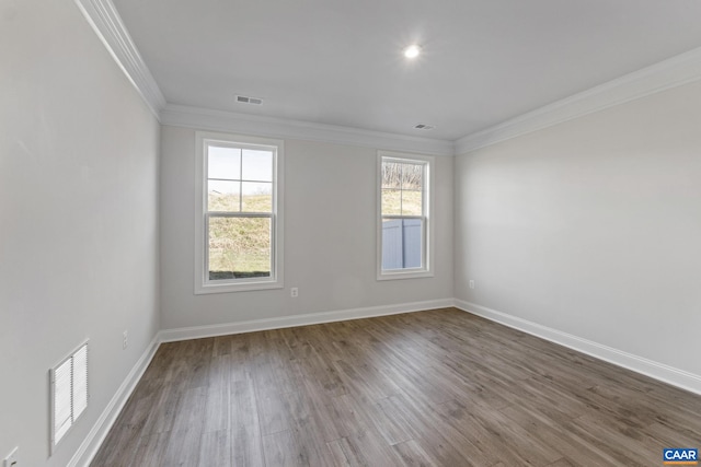 spare room with wood-type flooring and crown molding