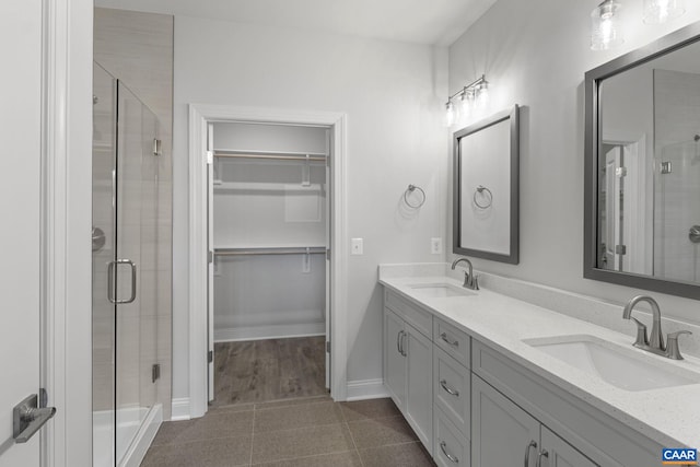 bathroom with hardwood / wood-style floors, vanity, and walk in shower