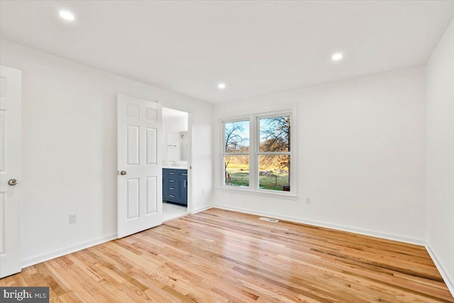 spare room featuring light hardwood / wood-style floors