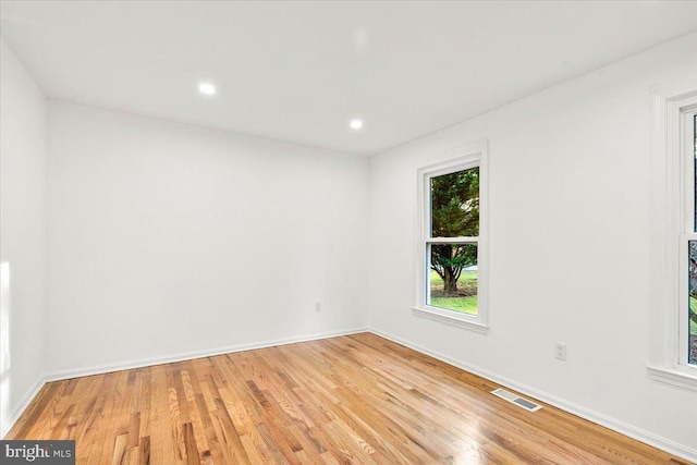 spare room featuring light hardwood / wood-style flooring