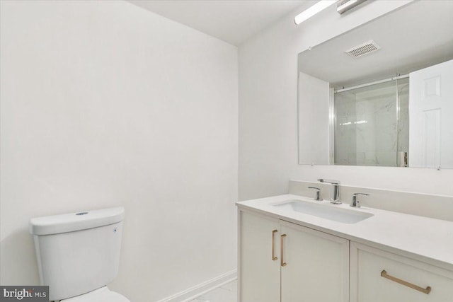 bathroom featuring vanity, toilet, and walk in shower