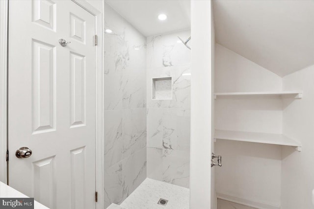 bathroom with a tile shower