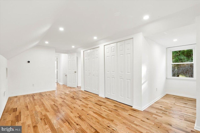 bonus room with light hardwood / wood-style flooring and vaulted ceiling