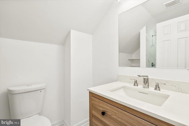 bathroom with vanity, toilet, walk in shower, and vaulted ceiling