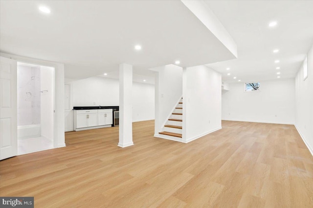 basement with light hardwood / wood-style flooring