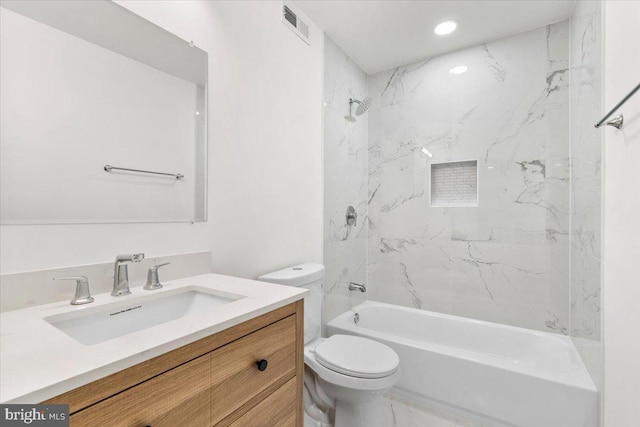 full bathroom featuring vanity, toilet, and tiled shower / bath