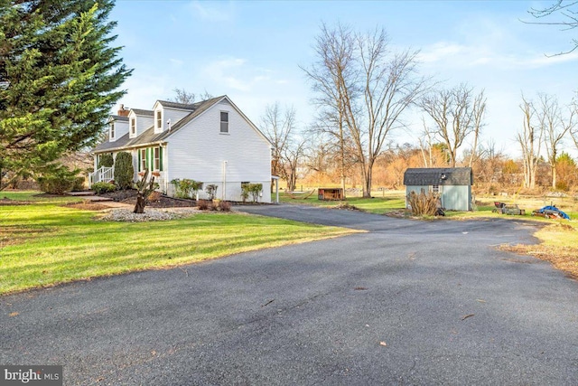 view of property exterior featuring a yard and a shed