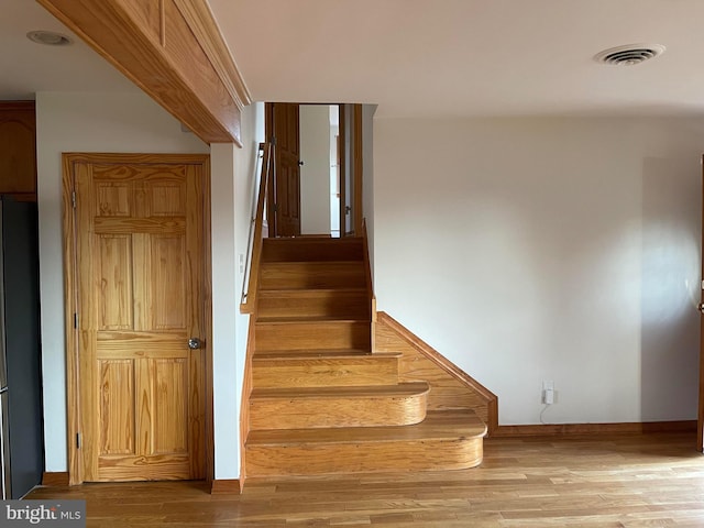 staircase featuring hardwood / wood-style floors