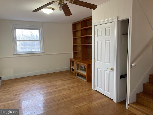 unfurnished living room with ceiling fan and light hardwood / wood-style floors