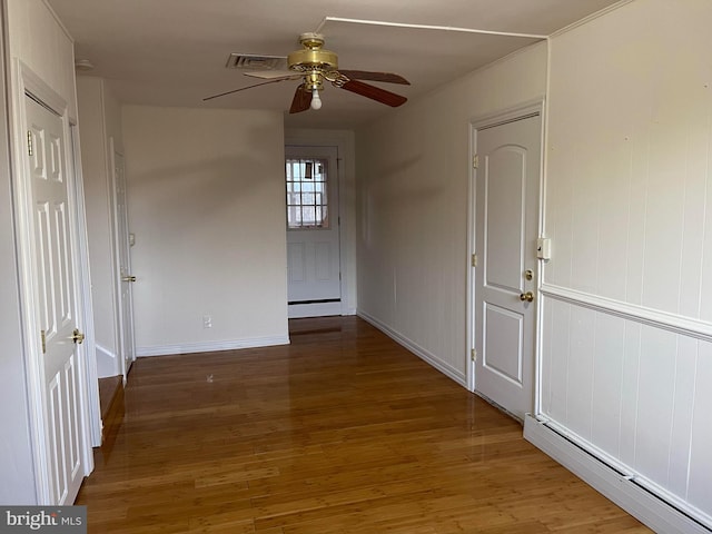 interior space with hardwood / wood-style floors and a baseboard heating unit