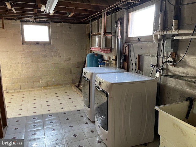 laundry room with independent washer and dryer and sink