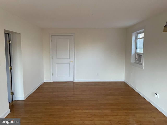 spare room with dark hardwood / wood-style floors and cooling unit