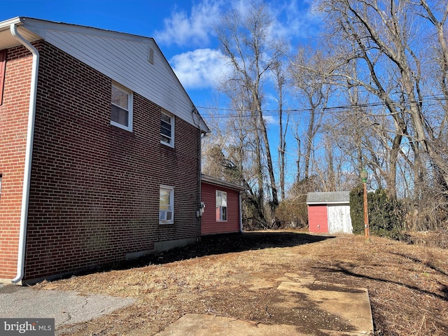 view of side of home with a shed