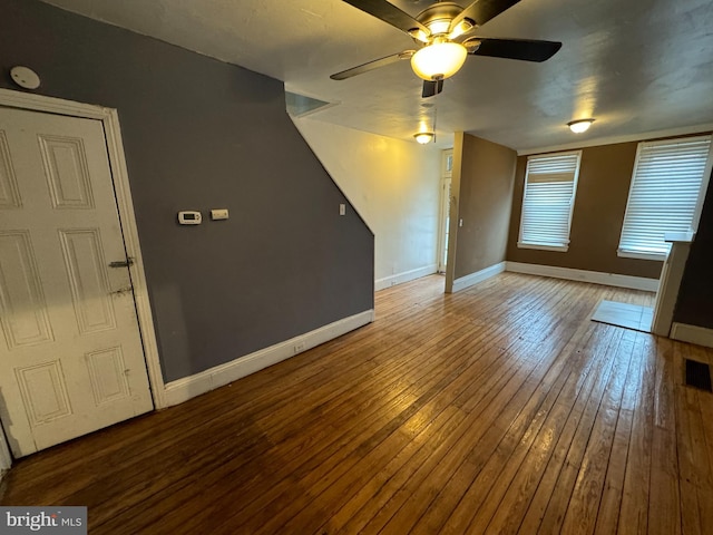 unfurnished living room with wood-type flooring and ceiling fan