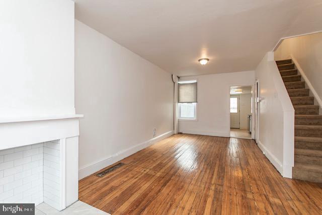 unfurnished living room with hardwood / wood-style flooring