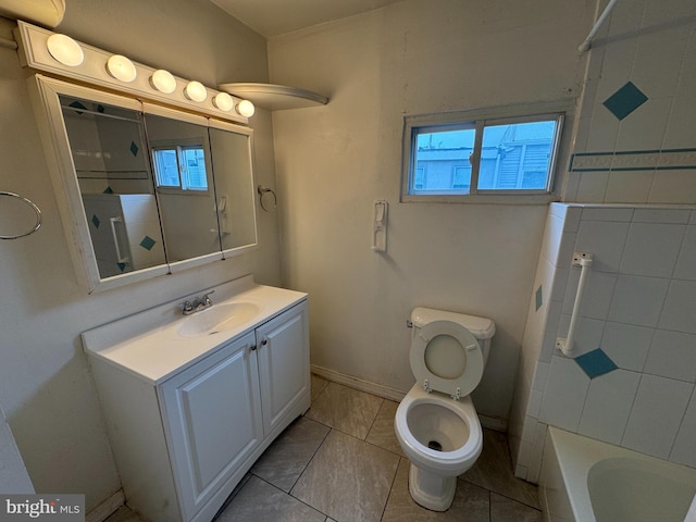 bathroom with tile patterned flooring, vanity, and toilet