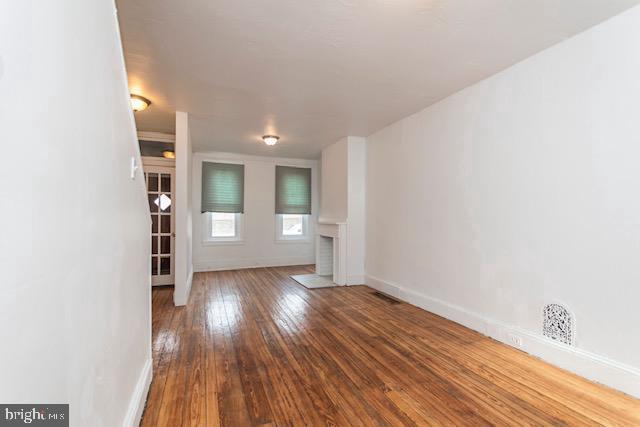 unfurnished living room featuring hardwood / wood-style flooring