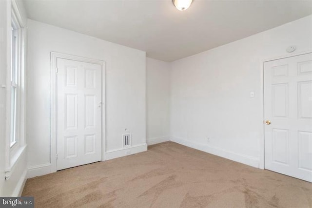 unfurnished bedroom with light carpet