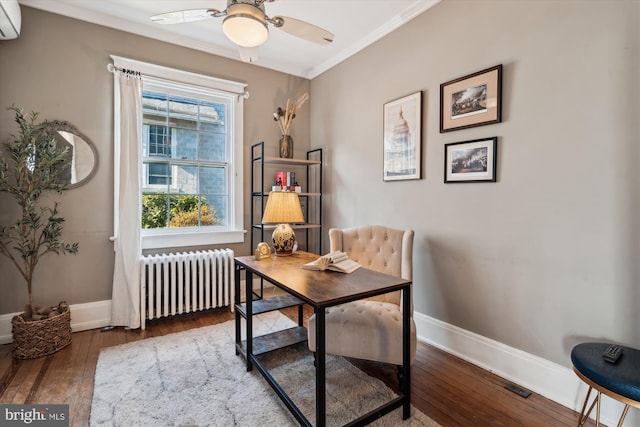 office area featuring a wall mounted air conditioner, crown molding, hardwood / wood-style flooring, ceiling fan, and radiator heating unit