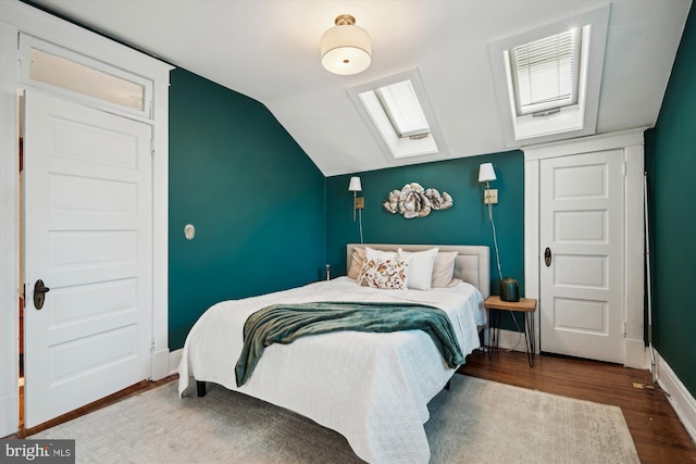 bedroom with wood-type flooring and lofted ceiling