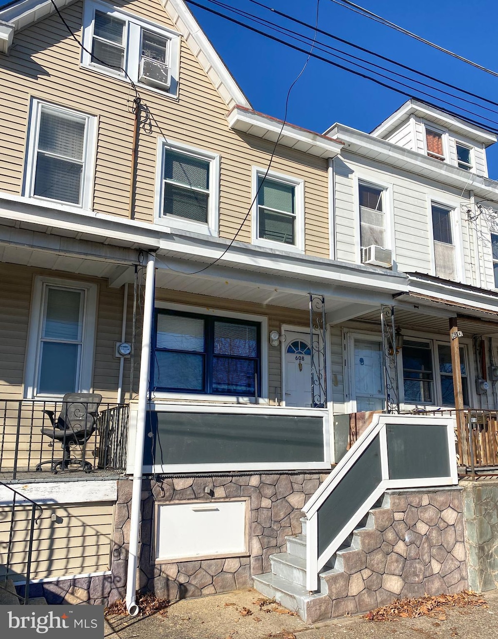 view of front of house featuring a porch and cooling unit