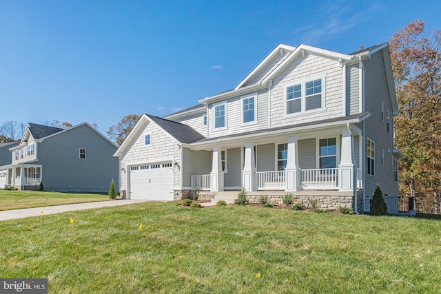 view of front of house with a front lawn, covered porch, and a garage