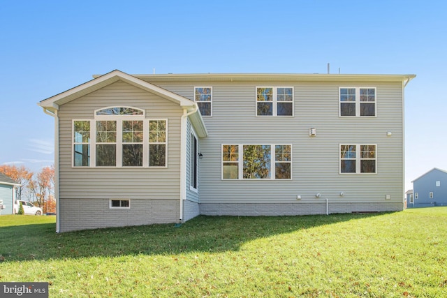 rear view of house featuring a lawn