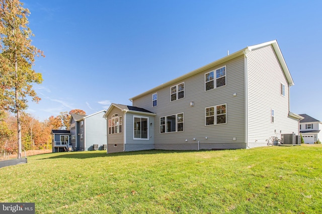 back of property with cooling unit and a yard