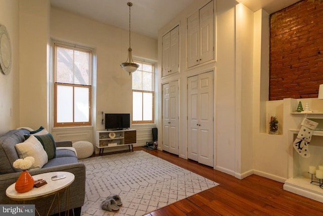 sitting room with dark wood-type flooring