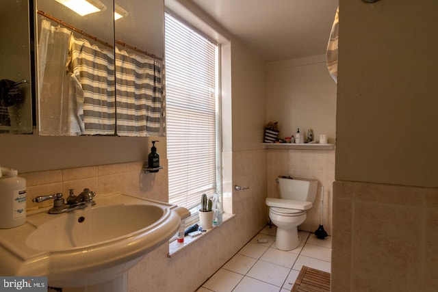 bathroom with sink, toilet, and tile patterned flooring