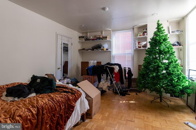 bedroom with light parquet floors